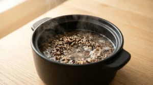 Wild rice blend cooking in a steaming pot of water, prepared for a chicken and wild rice soup recipe.